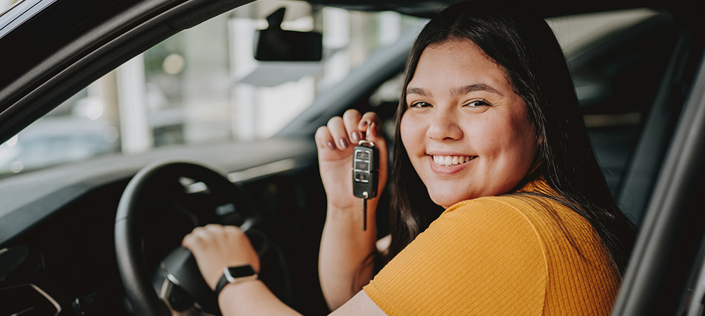 Girl holding keys to new car