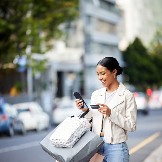 Young woman with mobile phone and bank card