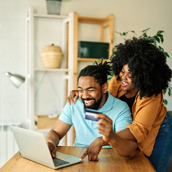 Couple with laptop and bank card