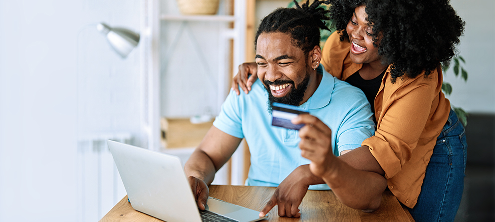 Couple with laptop and bank card