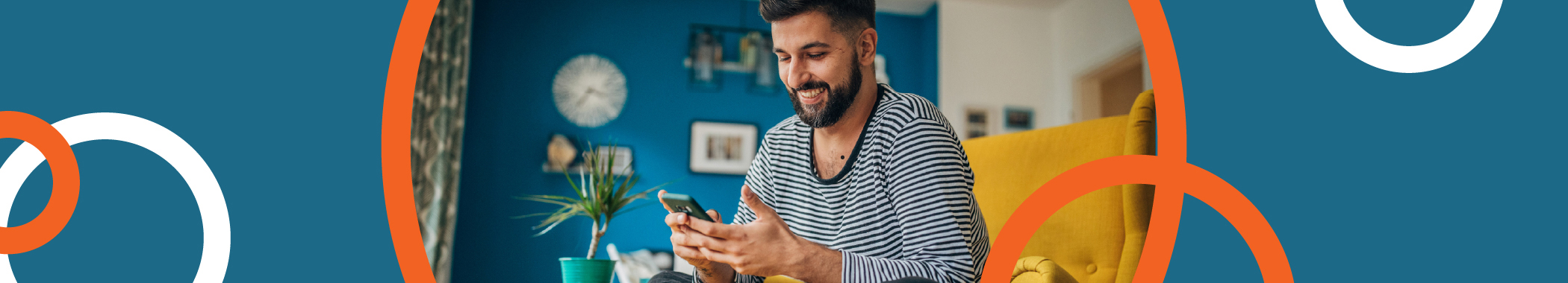 Young man at home in chair on phone