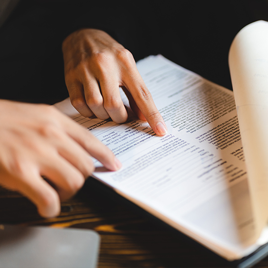 Hands pointing at paper