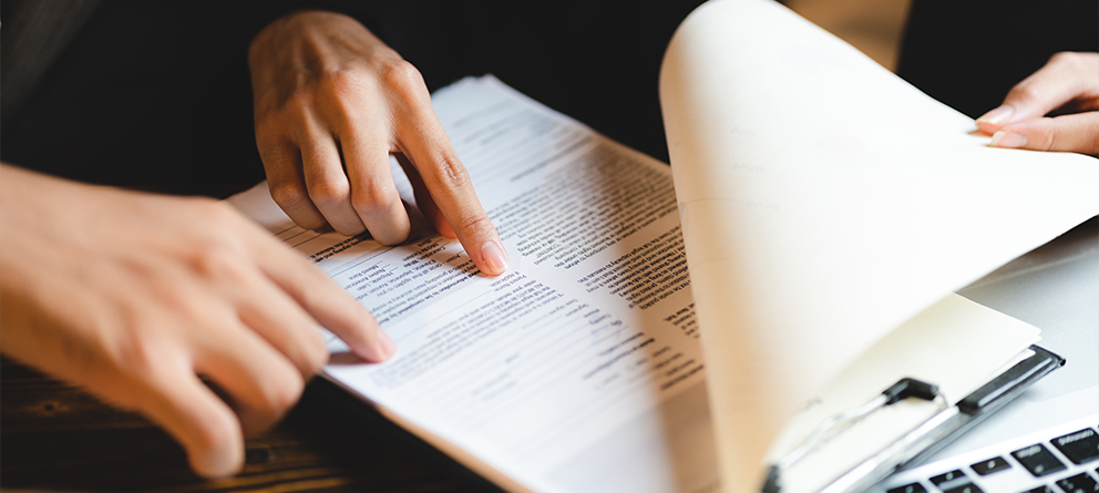 Hands pointing at paper