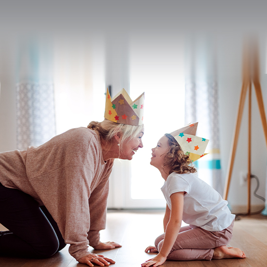 Grandparent and grandchild with paper crowns