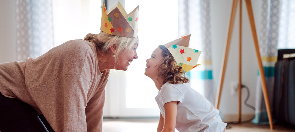 Grandparent and grandchild with paper crowns