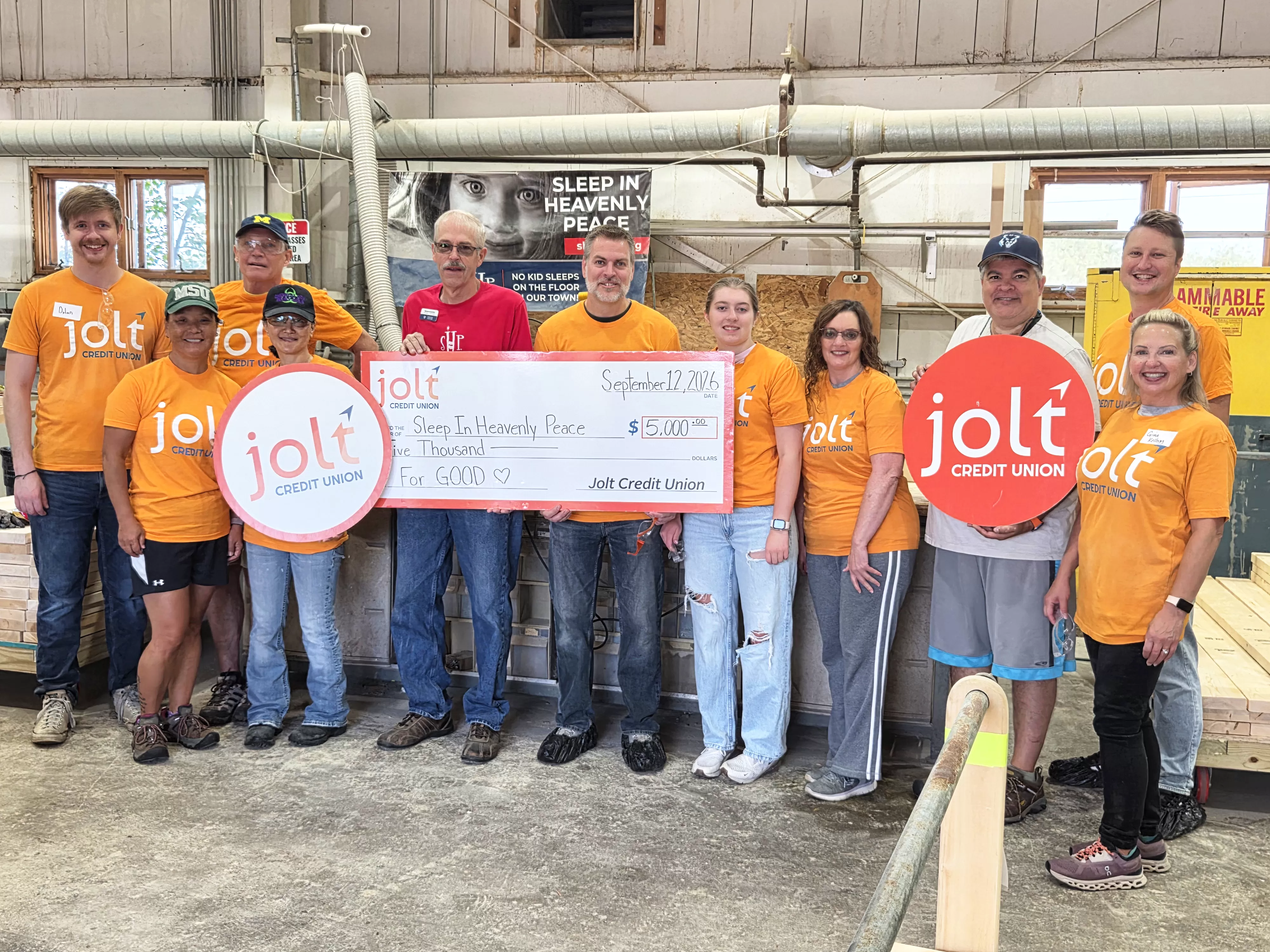 Jolt Credit Union employees presenting a $5,000 check to Sleep in Heavenly Peace as part of thier For GOOD initiative.
