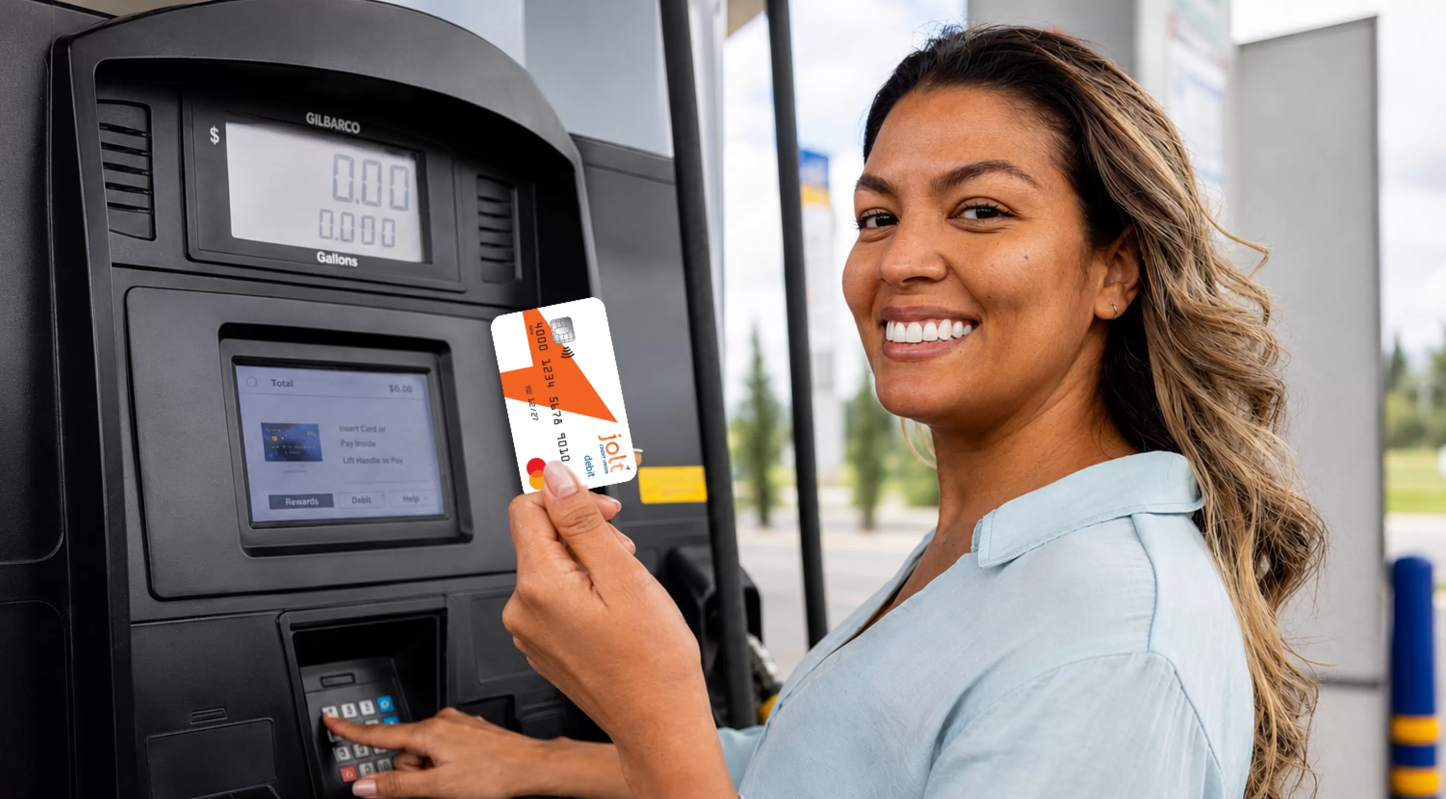 woman at gas pump holding jolt card