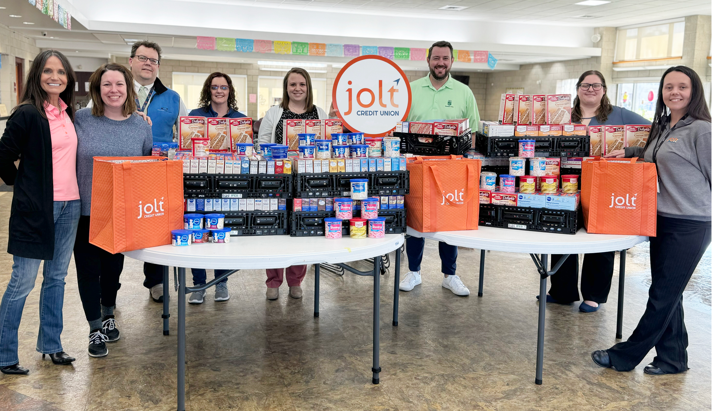 Jolt staff with cake mix donations from 2024